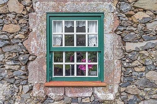 Aldeia da Cuada, Flores Island, Azores, Portugal. Paned window on a stone building. Art Print